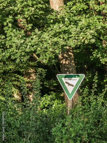 Vertical of a sign for the nature reserve oak and hornbeam forest at Hovingsfeld on a sunny day photo