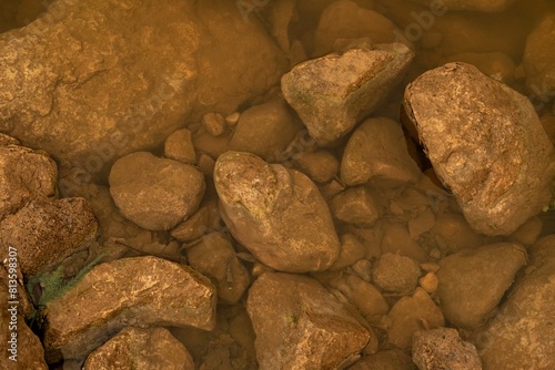 Top view of the big rocks and stones in the clear waters of a lake