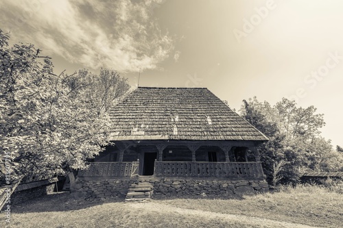 Beautiful shot of the Ilie Lazar's humble wooden house in the village of Giulesti, Maramures photo