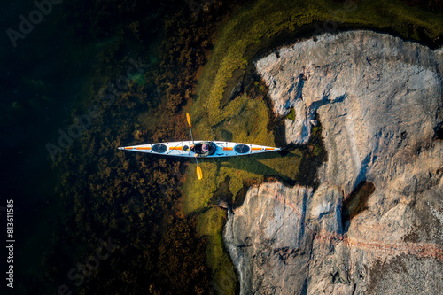 Summer Serenity: Aerial View of Kayaking in the Transparent Waters of the Swedish Archipelago (ID: 813611585)
