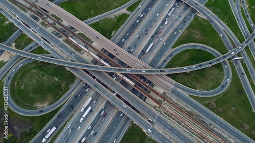 Aerial highway junction bustling with traffic, urban connectivity showcased Drone shot seamless flow, infrastructure strength. Efficient transportation, arterial roadways converge, pulse of city life.
