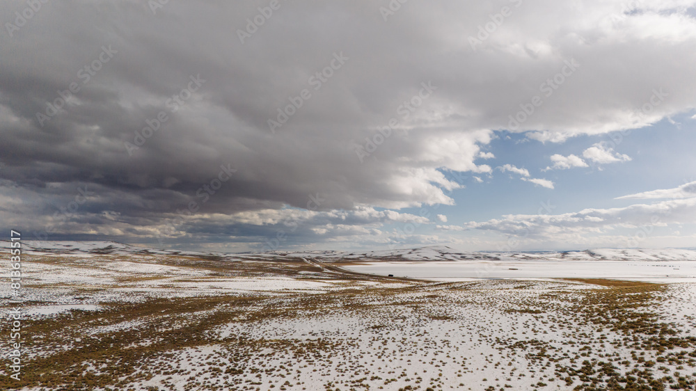 Picturesque snowy landscape on the background of a cloudy sky. Drone photo