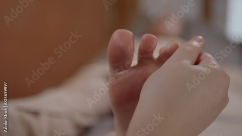 Hands of a masseuse massaging toes, feet to a woman Close-up, Thai foot massage