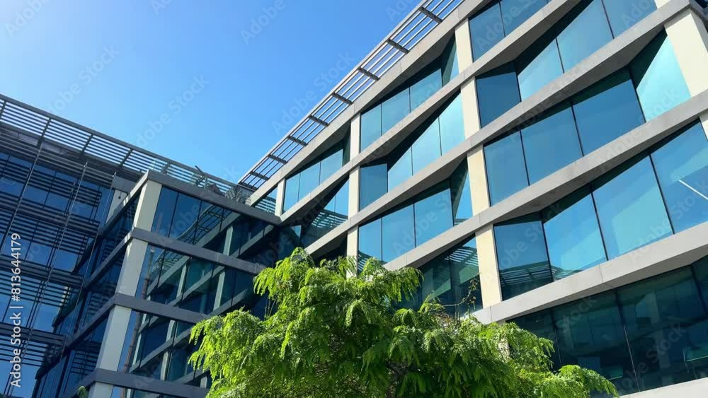 Modern glass office building exterior with reflection in the windows. Bottom up view. Wide angle shot. High quality 4k footage Modern glass office building exterior with reflection in the windows. Bottom up view. Wide angle shot. High quality 4k footage