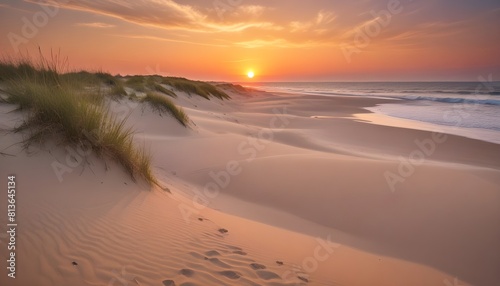 Footprints crisscross the sandy dunes as the sun sets  casting a warm golden glow over the landscape