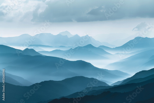 A tranquil view of the layers of mountain ridges disappearing into misty clouds  with their soft outlines and muted colors.