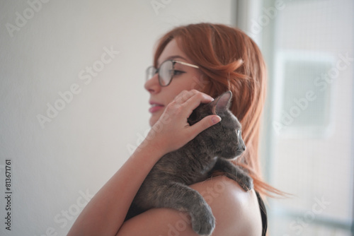 A young woman holding a cat pet portrait