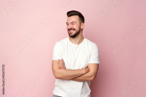 A man with a beard and a white shirt is smiling and looking at the camera