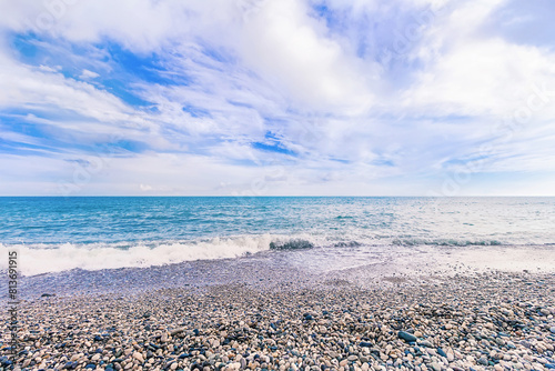 Summer sea beach landscape nature background wallpaper. Clear blue sea water on pebble beach. Summer vacation in Abkhazia, New Athos.