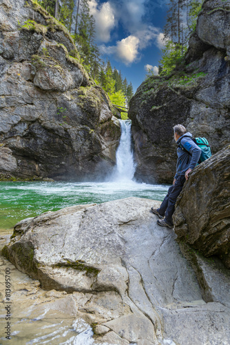 Germany, Bavaria, Allgaeu, male hiker in front of Buchenegger Wasserfalle, waterfall photo