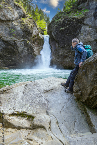 Germany, Bavaria, Allgaeu, male hiker in front of Buchenegger Wasserfalle, waterfall