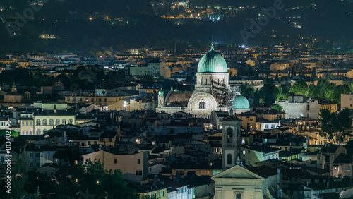 Synagogue of Florence night timelapse with green copper dome rising above surrounding suburban housing photo