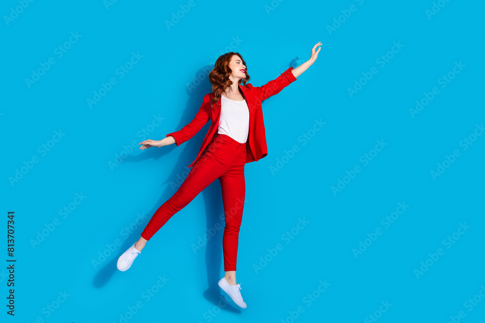 Photo of cheerful cute gorgeous girl wear red stylish clothes hold banner empty space isolated on blue color background Photo of cheerful cute gorgeous girl wear red stylish clothes hold banner empty space isolated on blue color background