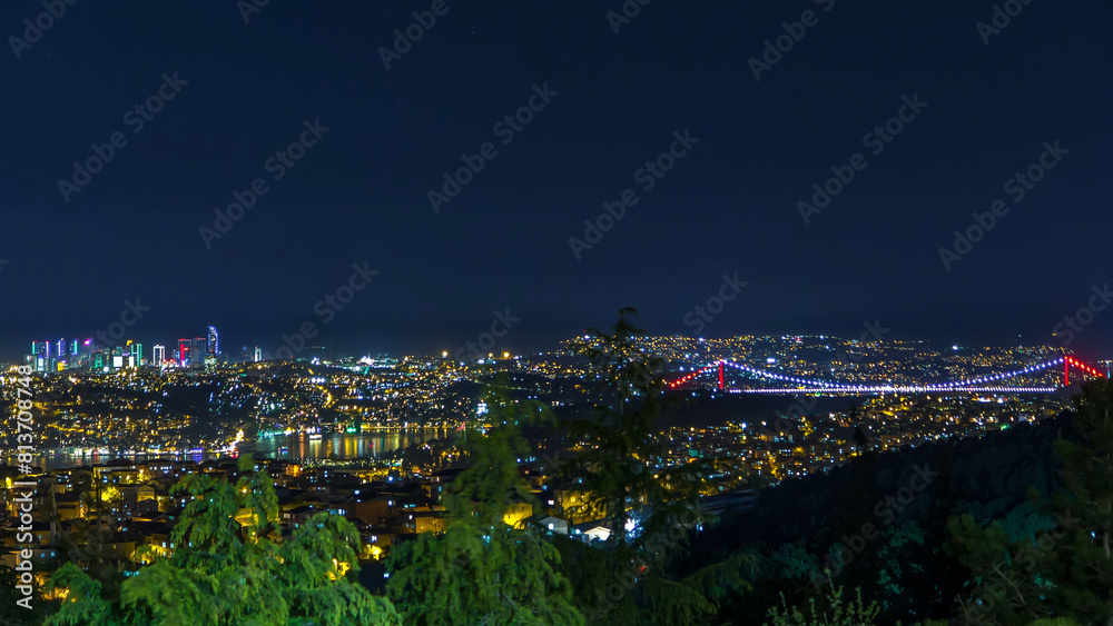 Obraz premium Fatih Sultan Mehmet Bridge view, connects Asia and Europe night timelapse from top of Camlyca hill. Istanbul, Turkey