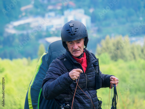Veteran pilot concentrates on checking his glider before starting the flight