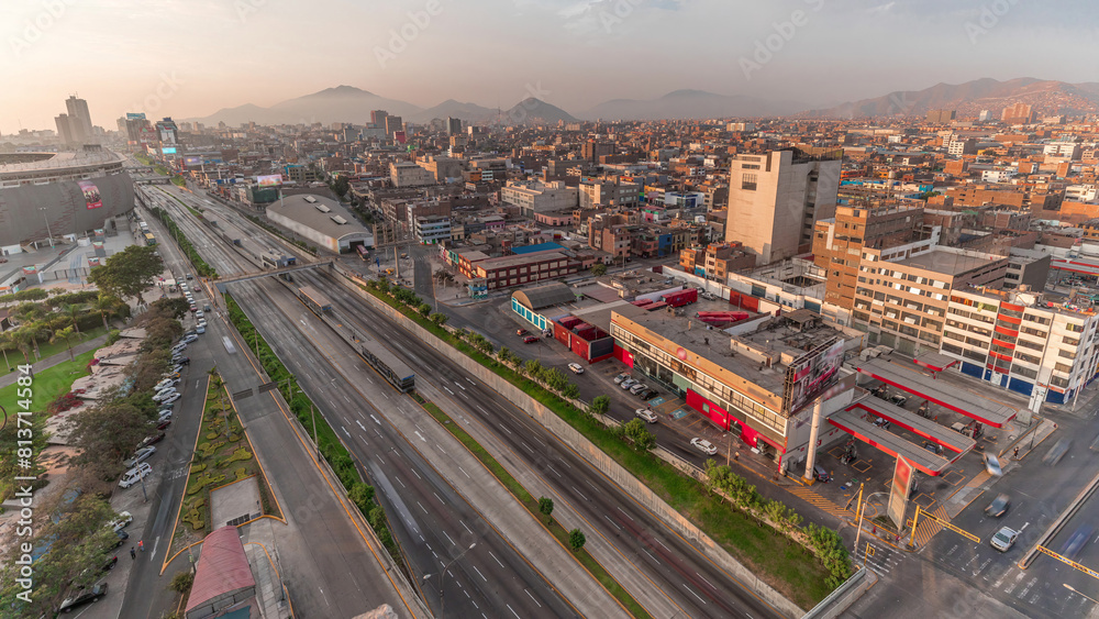 Aerial view of Via Expresa highway and metropolitan bus with traffic during sunset timelapse. Lima, Peru Aerial view of Via Expresa highway and metropolitan bus with traffic during sunset timelapse. Lima, Peru