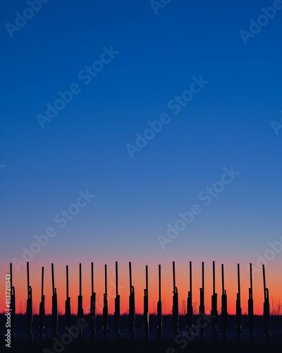 A minimalist image focusing on the silhouettes of multiple shotgun barrels aligned in perfect symmetry against a twilight sky.