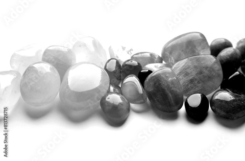 Healing chakra crystals, monochrome photo. Real semi-precious stones: rose quartz, amethyst, citrine, agate, apatite, kyanite, fluorite.