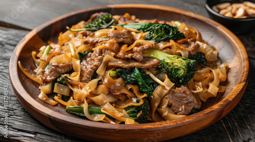 a depiction of a plate of  (Thai stir-fried noodles) served on a wooden platter, featuring wide rice noodles cooked with tender slices of beef or chicken, Chinese broccoli, and sweet soy sauce. photo