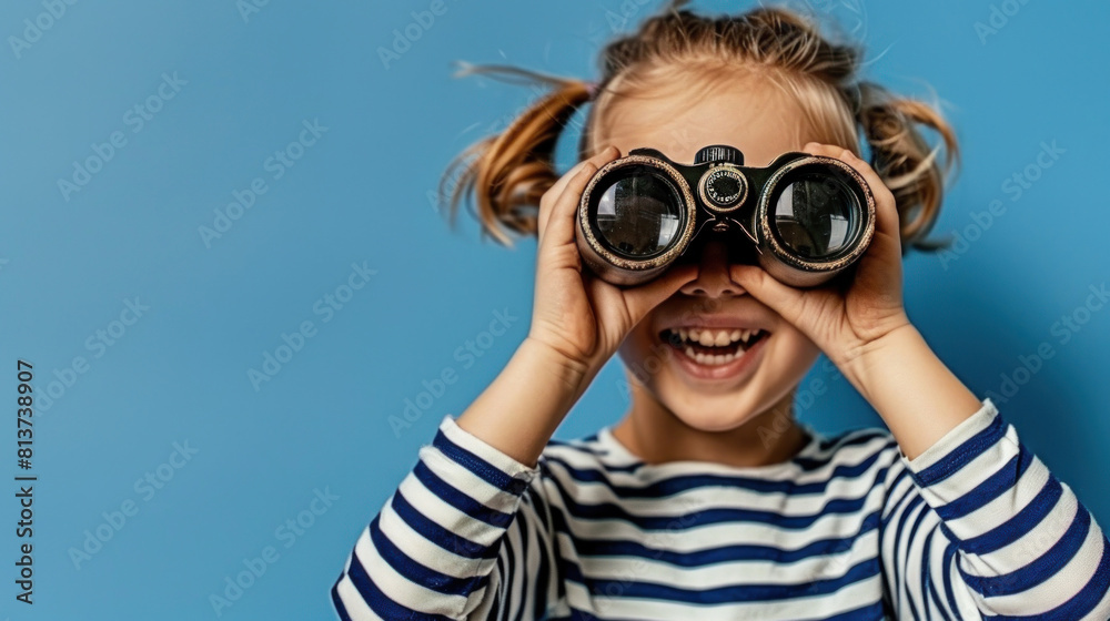 happy girl with Binoculars in striped clothes on blue background, banner, copy space happy girl with Binoculars in striped clothes on blue background, banner, copy space