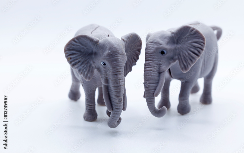 Fototapeta premium two plastic toy elephants on a white background