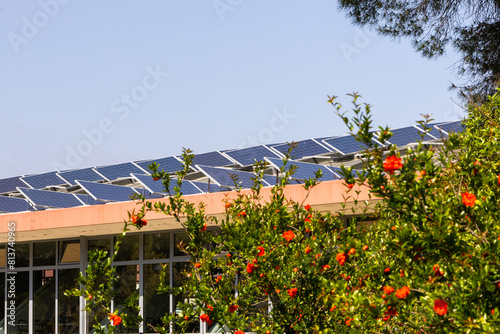 Solar panels on building roof amidst nature