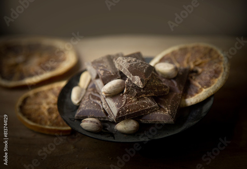 .pieces of chocolate and pistachios on a dark background