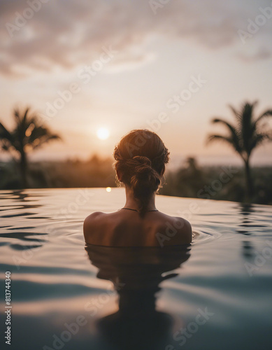 Portrait of woman in infinity pool in Bali  sunset view 