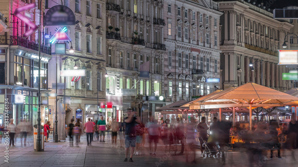 Fototapeta premium People is walking in Graben St. night timelapse, old town main street of Vienna, Austria.