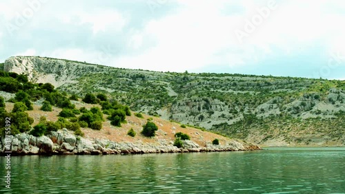 Hilly and overgrown shrubs of shore of Novigrad sea in Zadar County, Croatia. photo