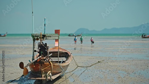 Traditional wooden boat of the locals on the beach on Koh Mook Island. photo