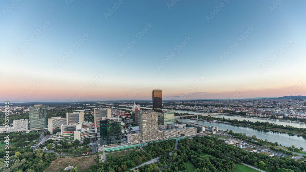 Aerial panoramic view over Vienna city with skyscrapers, historic buildings and a riverside promenade day to night timelapse in Austria. Aerial panoramic view over Vienna city with skyscrapers, historic buildings and a riverside promenade day to night timelapse in Austria.