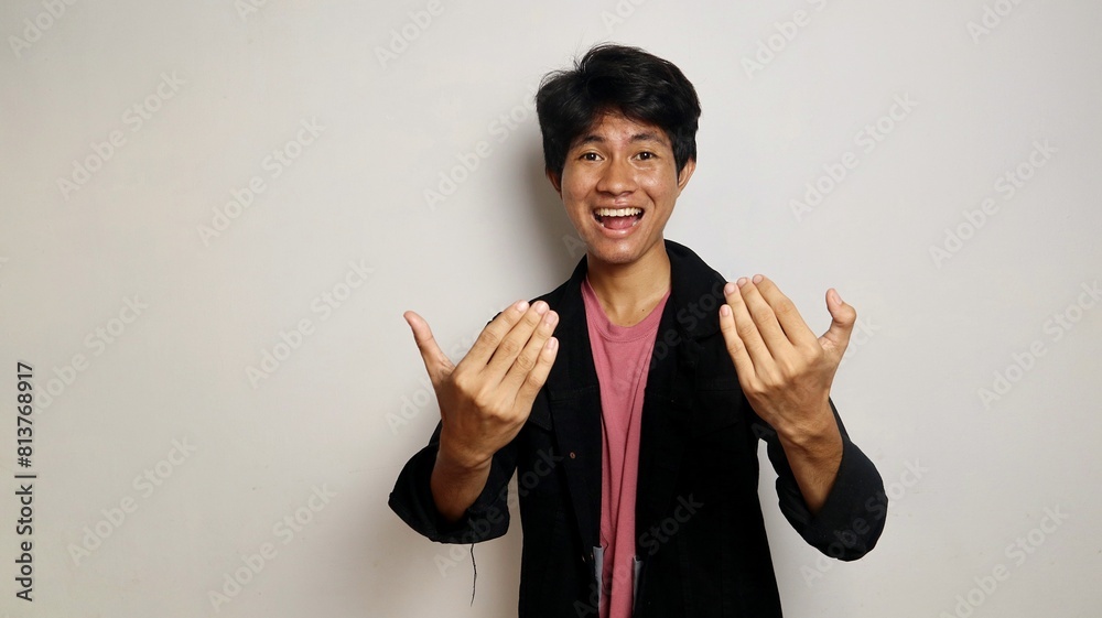 Young Asian handsome man over isolated white background inviting to come with hand