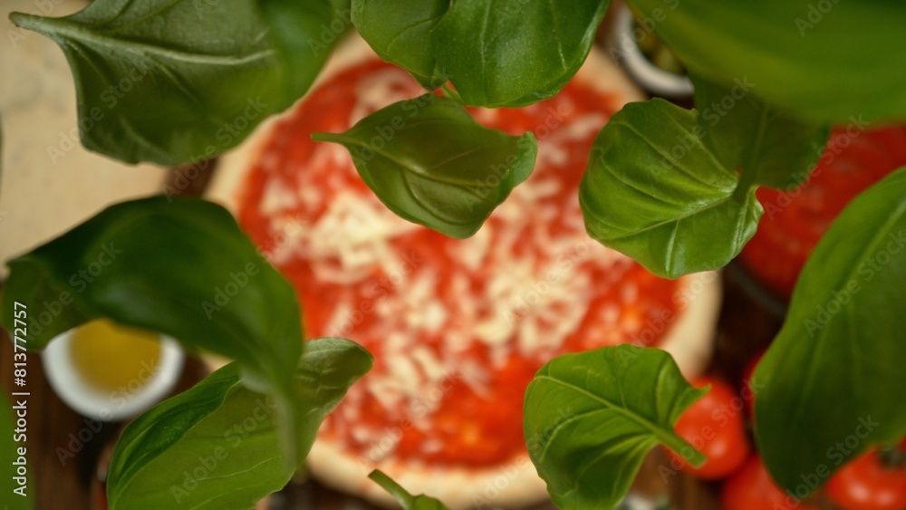 Obraz premium Delicious pizza with flying ingredients from above.