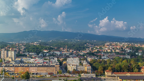 Panorama of the city center timelapse of Zagreb, Croatia, with modern and historic buildings, mountains on background. © neiezhmakov
