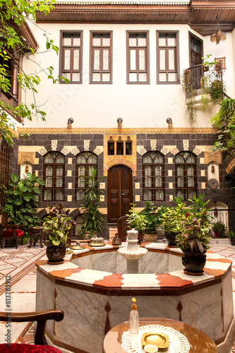 Interior of luxury hotel in oriental style with living plants and fountain in the lobby