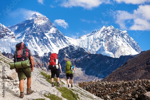three hikers and mounts Everest Lhotse from Gokyo valley