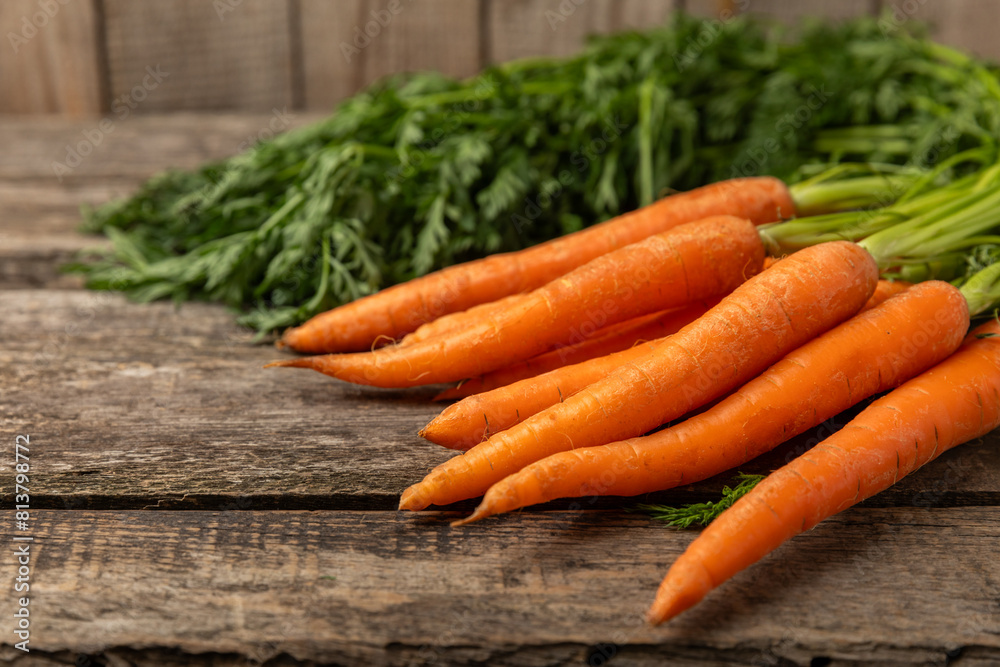 Carrots on a textured wooden background. Fresh and sweet organic carrots on a white background. Carrot slices. Vegan. Ingredients for salad. Place for text. Copy space. Flatley Carrots on a textured wooden background. Fresh and sweet organic carrots on a white background. Carrot slices. Vegan. Ingredients for salad. Place for text. Copy space. Flatley