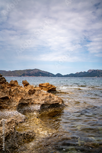 Rocky beach in the Victoria town in Mallorca Spain on a cloudy summer day