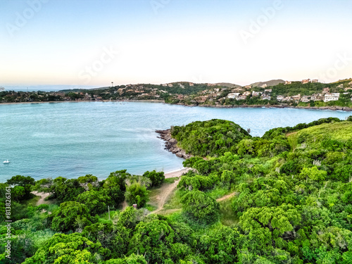 Top down aerial view of the coast of the ocean with clear turquoise water, trees, resort town, bay.  Perfect for nature themes and background use. drone shoot photo