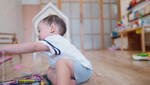 Little cute asian male son sitting playing modeling clay with his nanny inside cozy living room. Active playful kid staring learning how to do. Art Colorful Craft Toy. Child Education. Child Day Care