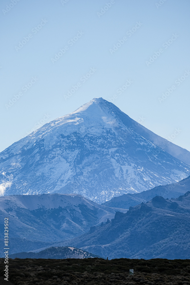 Lanin volcano surrounded by clouds, clear summit in sight and ice glaciers, between Argentina and Chile, Lanin National Park Lanin volcano surrounded by clouds, clear summit in sight and ice glaciers, between Argentina and Chile, Lanin National Park