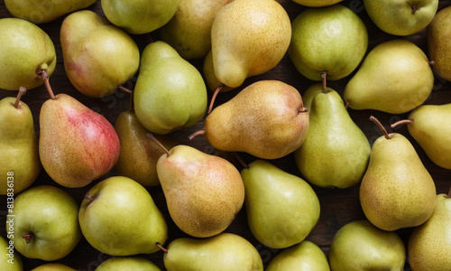 Various apples and pears tightly packed together, with both green and red apples and green pears visible, all having their stems intact.