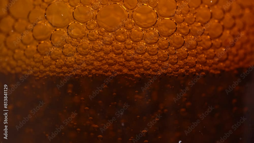 Macro shot of various air bubbles in water rising up on bright brown background. Slow motion. Cosmetics background Macro shot of various air bubbles in water rising up on bright brown background. Slow motion. Cosmetics background