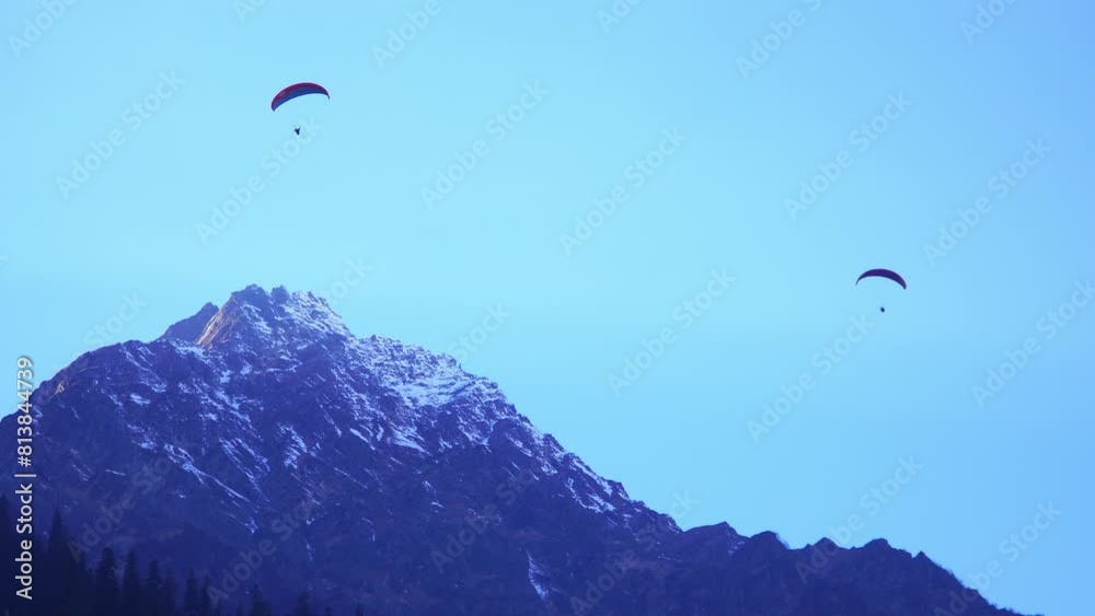 people are skydiving above the snow mountains people are skydiving above the snow mountains
