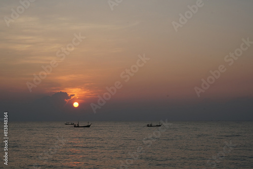 The perspective of the fishing boat in the sea with a sunrise background