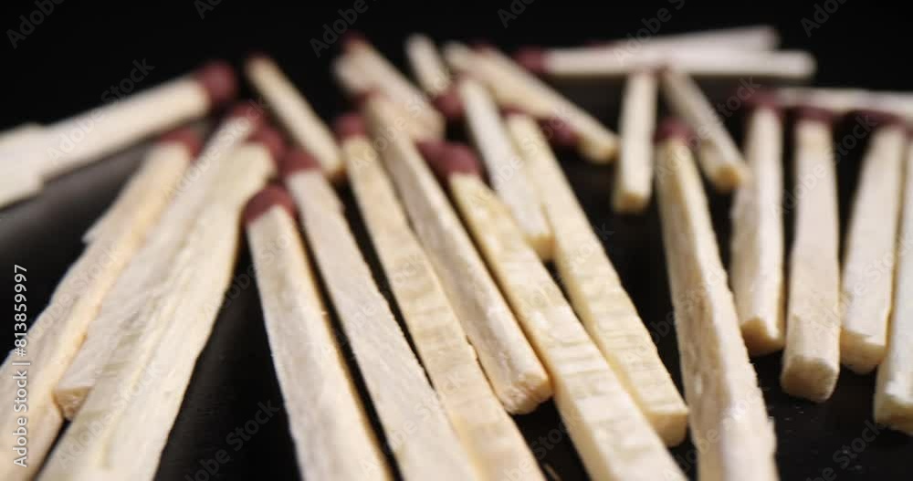 Pile of wooden matches on dark background. Wooden matches for making a fire or cooking Pile of wooden matches on dark background. Wooden matches for making a fire or cooking