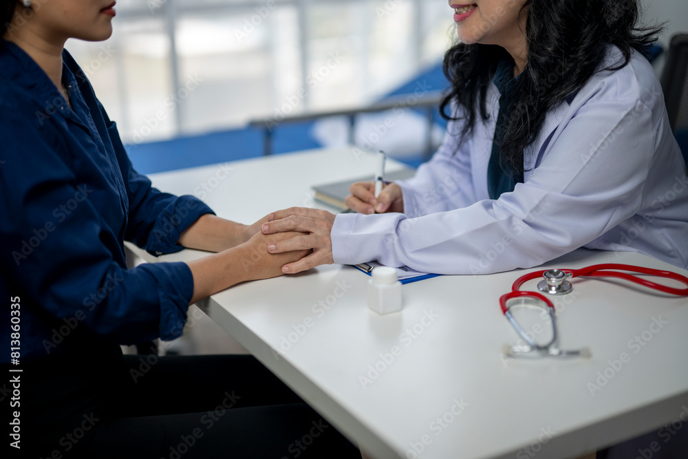 Fototapeta premium A woman is sitting at a desk with a doctor