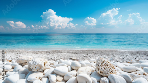 White stones on sand with the sea horizon