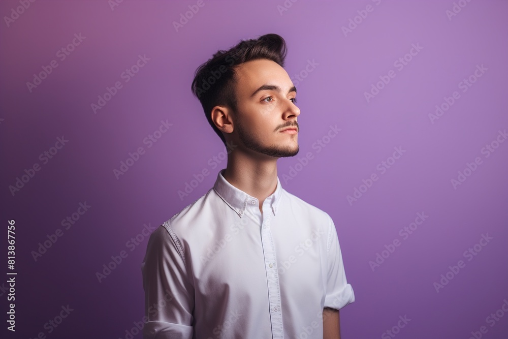 Fototapeta premium A man in a white shirt is standing in front of a purple background
